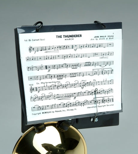 The DEG C260 Trumpet and Cornet Lyre attached to a trumpet with the piece "The Thunder" by J. P. Sousa in the folder.