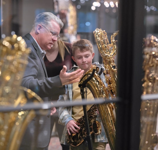 Daryk showing a child a bari saxophone