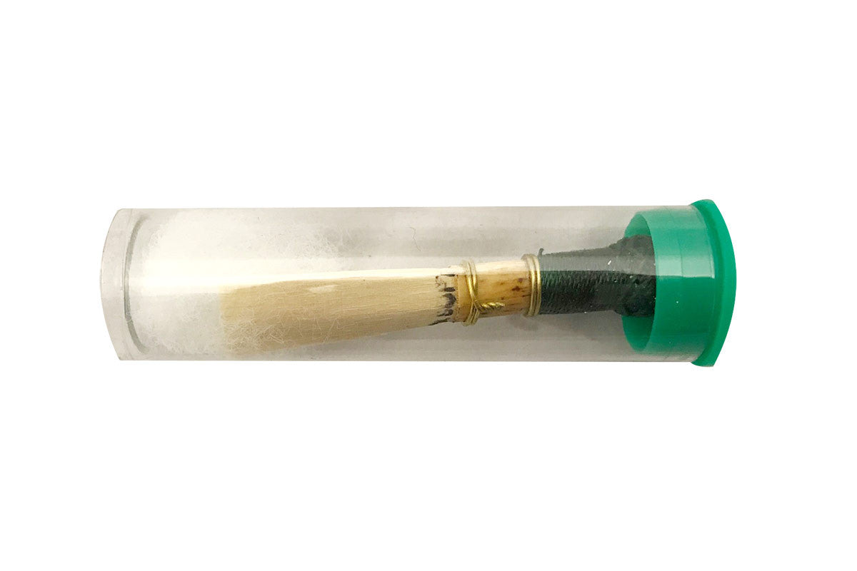 Emerald Bassoon reed in its clear plastic packaging tube