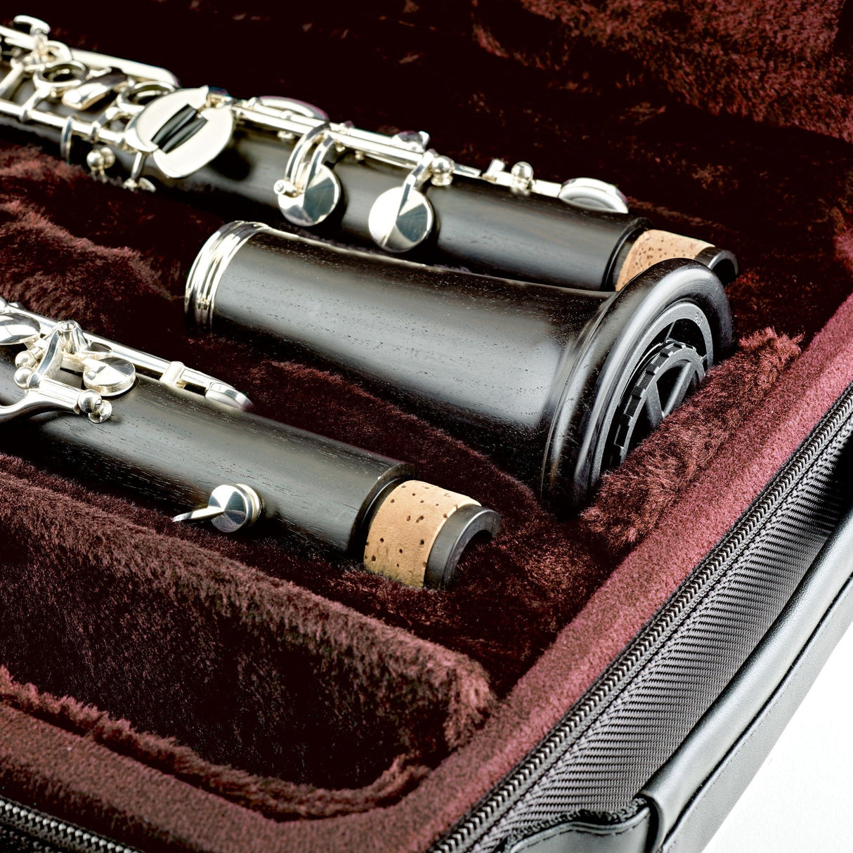 The K&M 15228 clarinet stand fully collapsed and fitted in to a clarinet bell which is sitting inside of a clarinet case