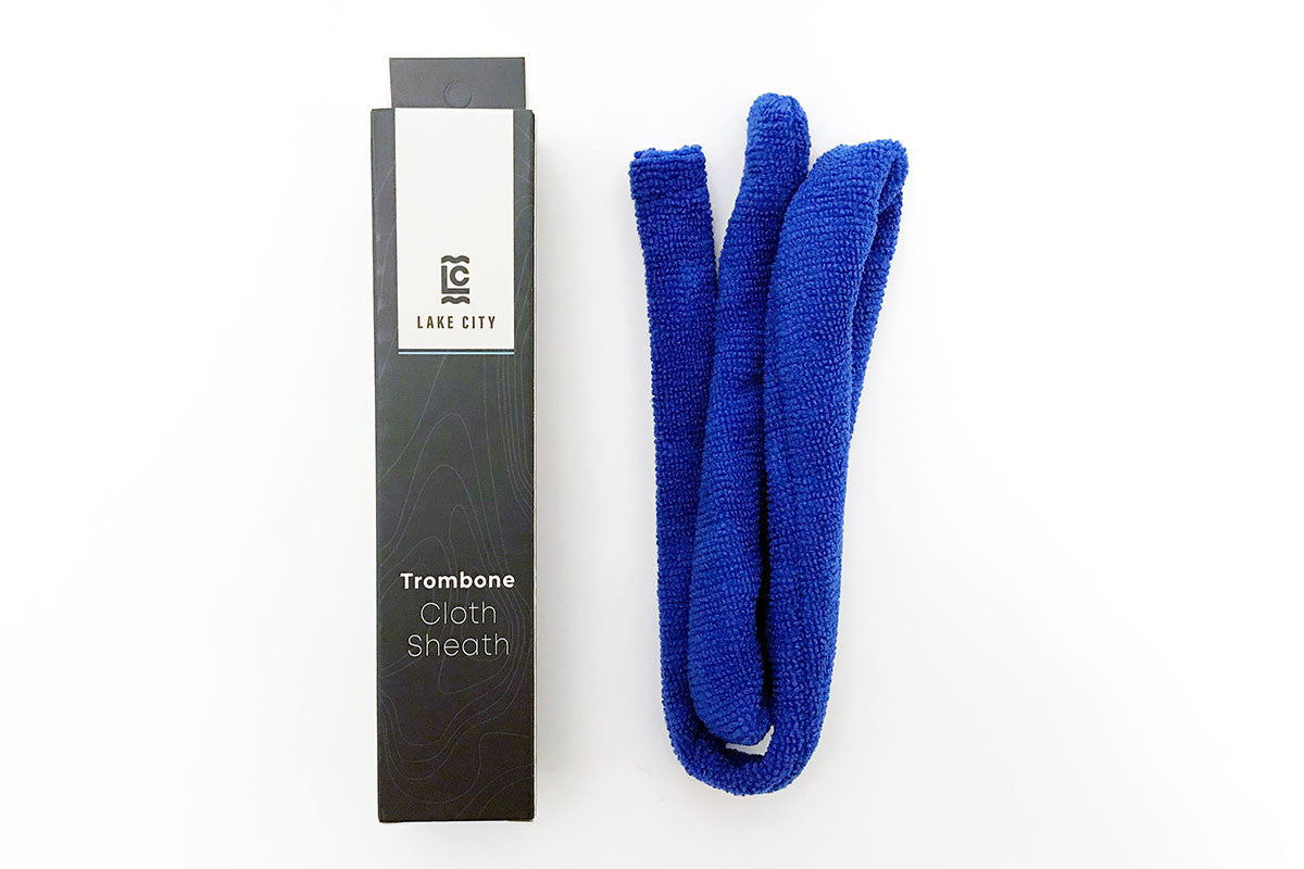 The blue lake city trombone slide sheath next sitting next to its blue packaging box