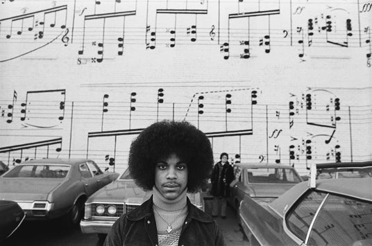 Singer Prince in front of Schmitt Music wall in Minneapolis, MN