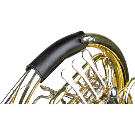 The Protect L227 black leather hand guard for french horn attached to a french horn.