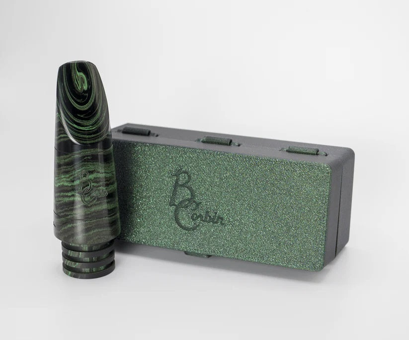 B. Corbin Signature Marbled Hard Rubber Bb Clarinet Mouthpiece - a green marbled mouthpiece standing outside of its green plastic case