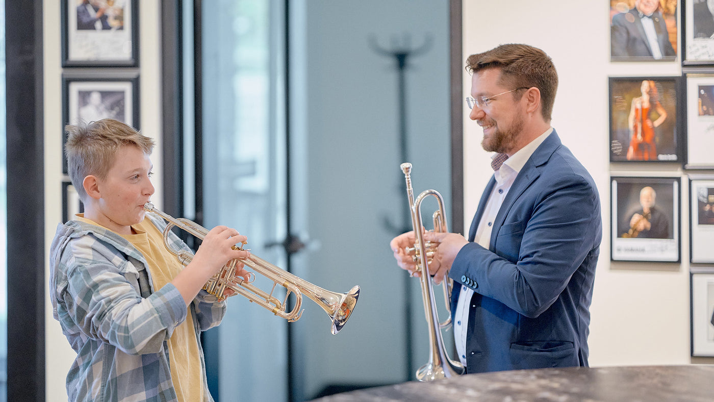 Ben teaching trumpet to a student