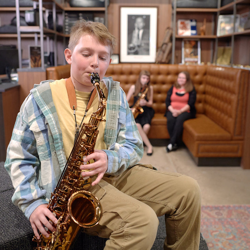 Boy playing a saxophone in the Sax Shop