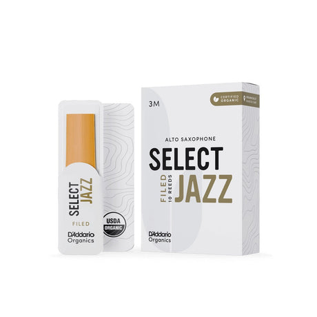 A box of D'addario Organic Select Jazz filed alto saxophone reeds with a single reed sitting next to it