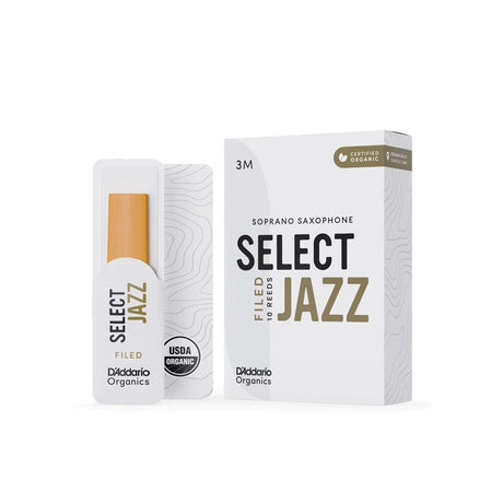 A box of D'addario Organic Select Jazz filed soprano saxophone reeds with a single reed sitting next to it