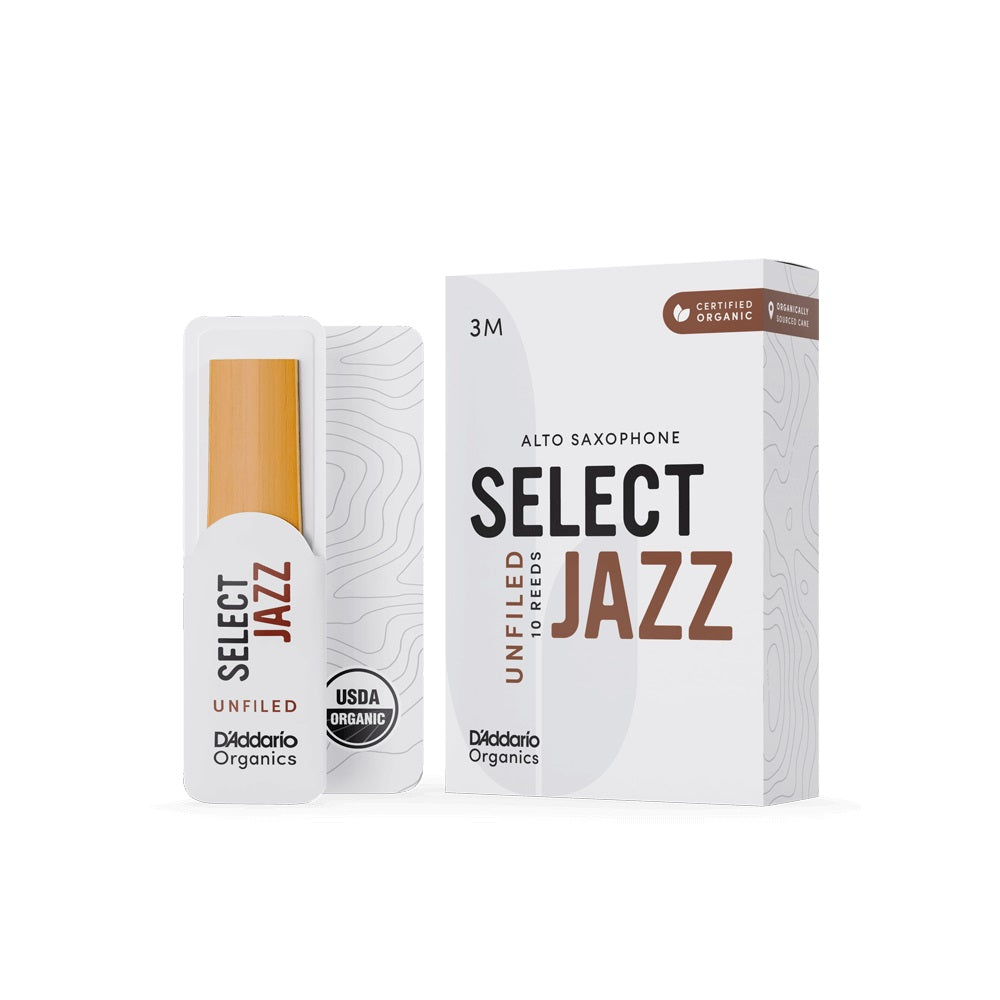 A box of D'addario Organic Select Jazz unfiled alto saxophone reeds with a single reed sitting next to it