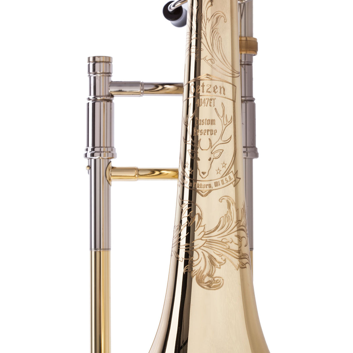 Getzen 4047ET Custom Reserve Large Bore Tenor Trombone - close up of the elk head engraving and logo on the bell