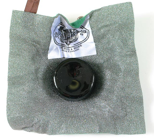 Hill Dark Rosin, opened, with the cake of rosin sitting on top of the cloth wrapping