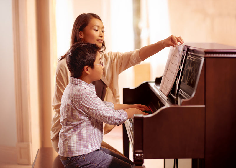 kid playing on piano