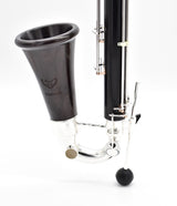 Royal Global Firebird Low C Bass Clarinet - close up of bell attached to lower joint with instrument resting on its peg