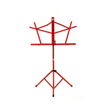 Red Schmitt Music folding music stand standing upright with its facing support flared open