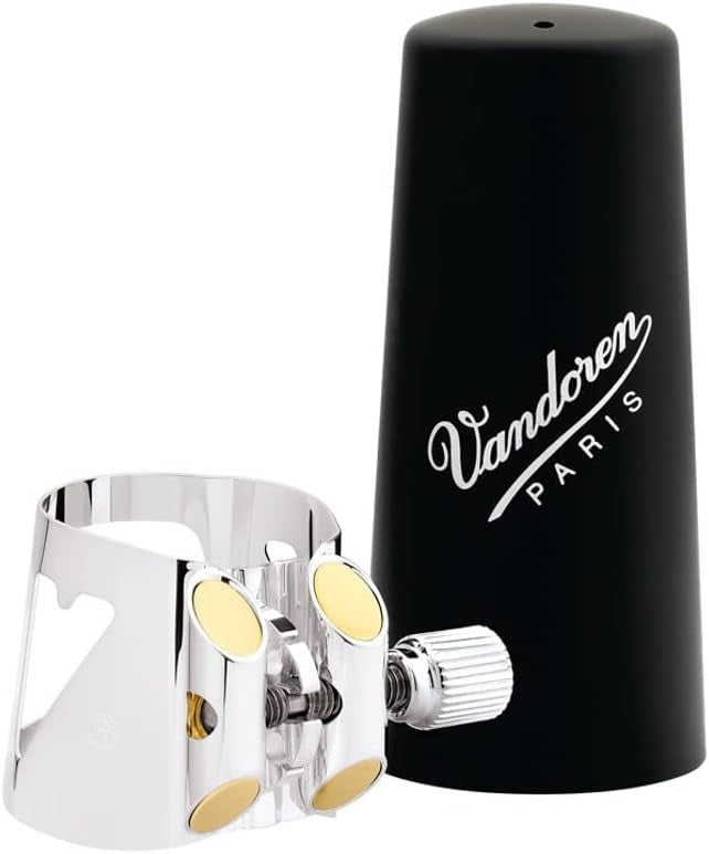 The Vandoren Optimum Silverplated Bass Clarinet ligature next the included black plastic mouthpiece cap